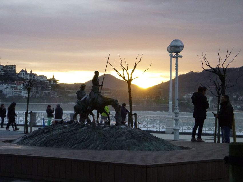 Don Quixote in Plaza Cervantes at sunset