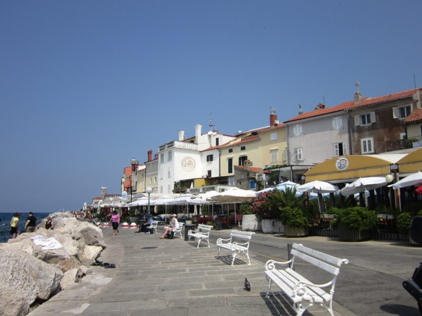 Waterfront Promenade, breakwater on one side and cafes on the other.